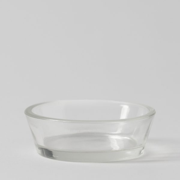 Clear shallow round glass dish with tapered sides and a thick rim on a pale grey background, the Boo's Treats Replacement Dish