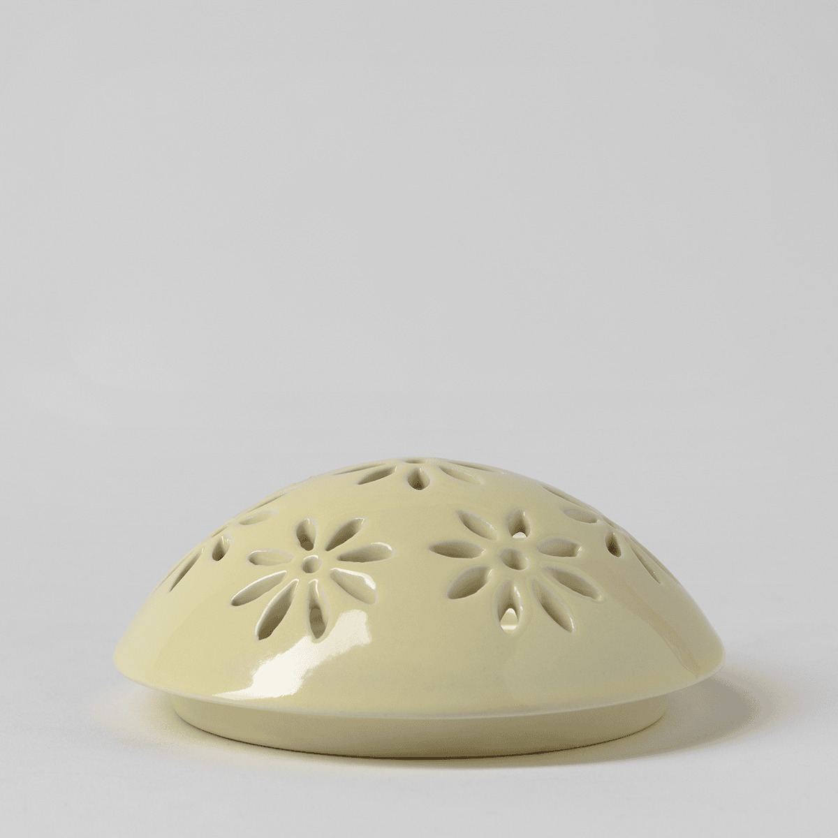 Pale yellow glossy ceramic dome with cut-out daisy flower shapes, the Easter Garden - Yellow Replacement Lid for a Scentsy warmer