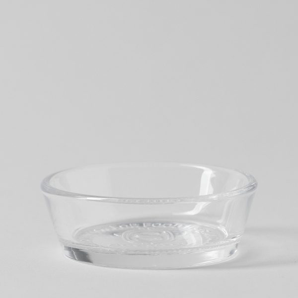Clear round glass dish with a shallow curved bowl and an embossed logo on the base, the Ghostlight Gourd Replacement Dish
