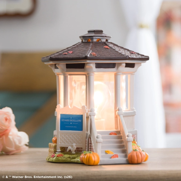 Decorative warmer shaped like a gazebo with white pillars, dark roof, and autumn pumpkins at the base, the Gilmore Girls: Welcome to Stars Hollow Scentsy Warmer