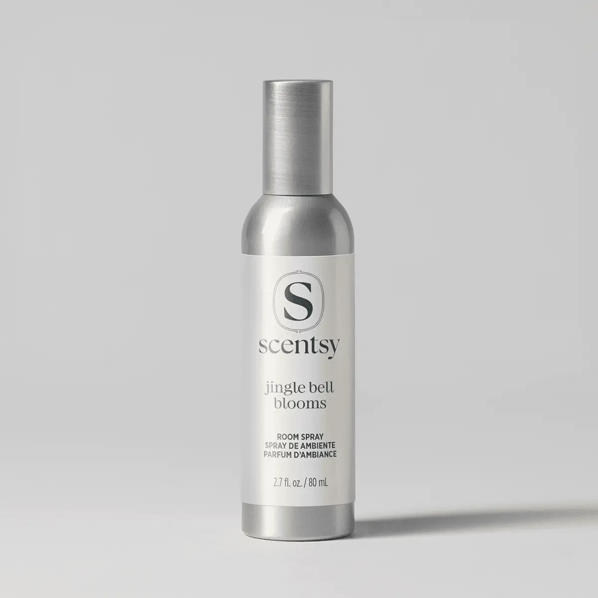 Metallic silver spray bottle with white label featuring the Scentsy logo and text reading Jingle Bell Blooms Room Spray, 2.7 fl. oz./80 mL