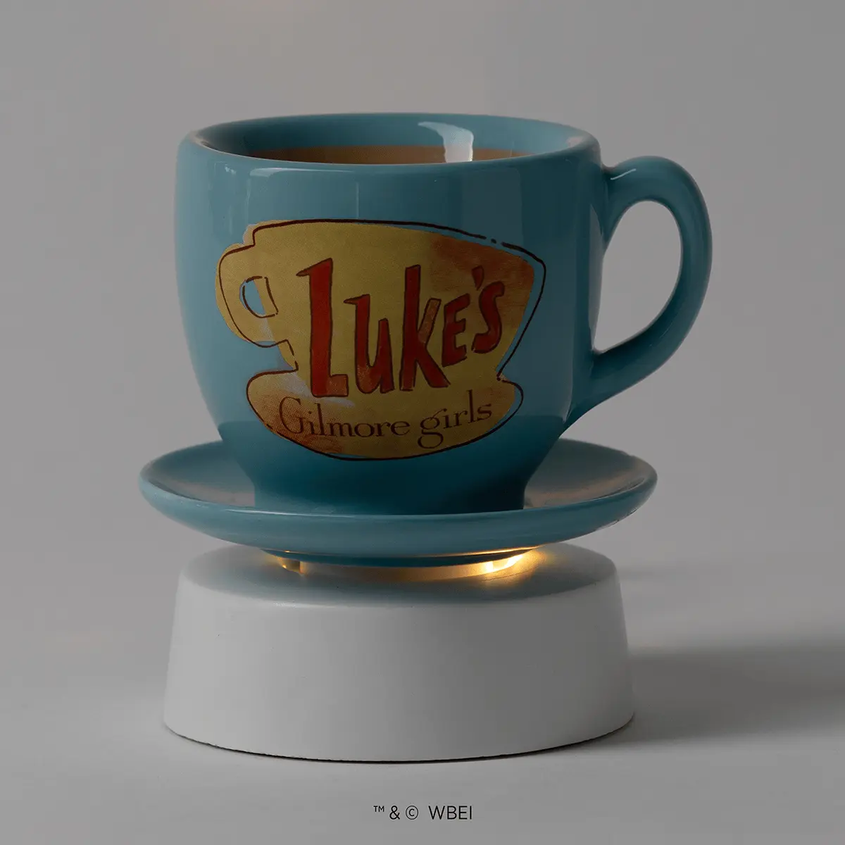 Teal ceramic mug-shaped warmer with "Luke's Gilmore girls" logo and matching saucer base with gold accent, the Luke's Coffee Mug Mini Scentsy Warmer