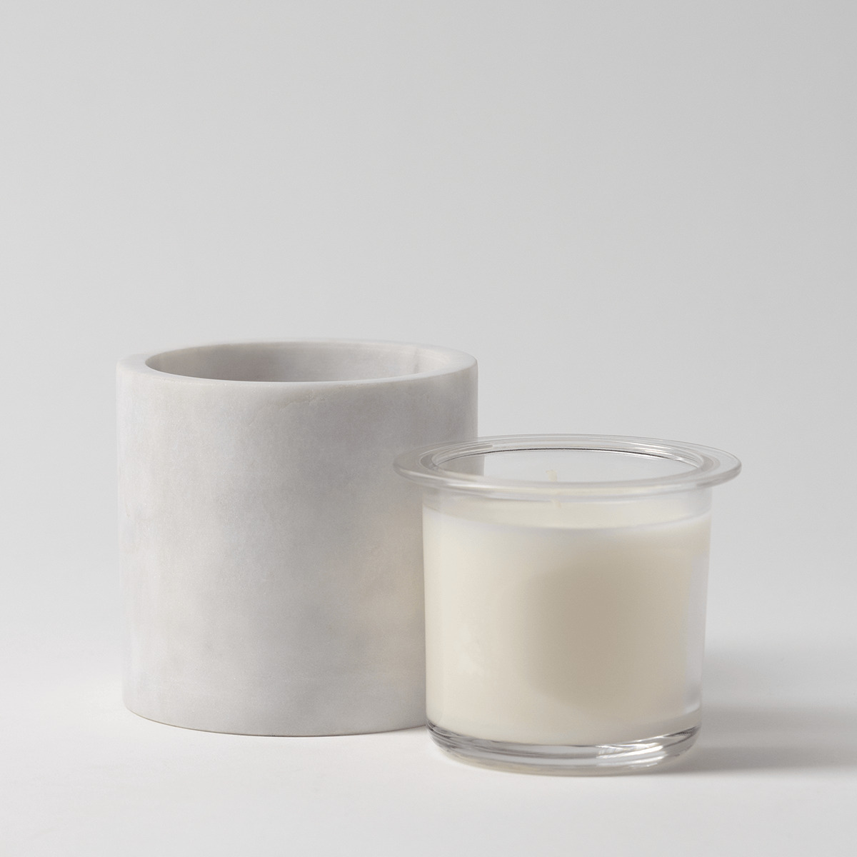 White marble candle holder with natural veining, shown with a clear glass Scentsy Candle Insert filled with cream wax