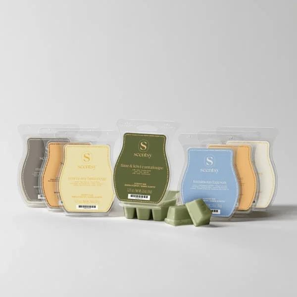 Collection of Scentsy wax bars in clear plastic clamshell packaging, including olive-green lime and kiwi cantaloupe, pale yellow you're my buttercup, blue luminous lagoon, and neutral-toned bars, with loose green wax melts displayed in front, the October Bring Back My Bar Bundle