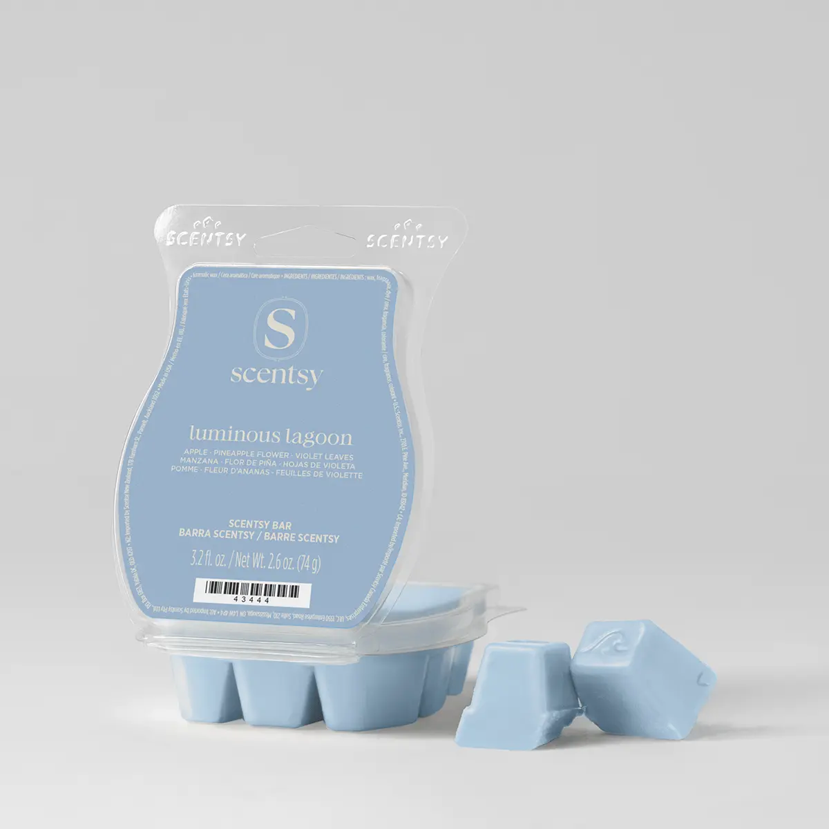 Light blue wax bar in a clear clamshell package labelled "luminous lagoon" with the Scentsy branding, accompanied by two loose wax cubes