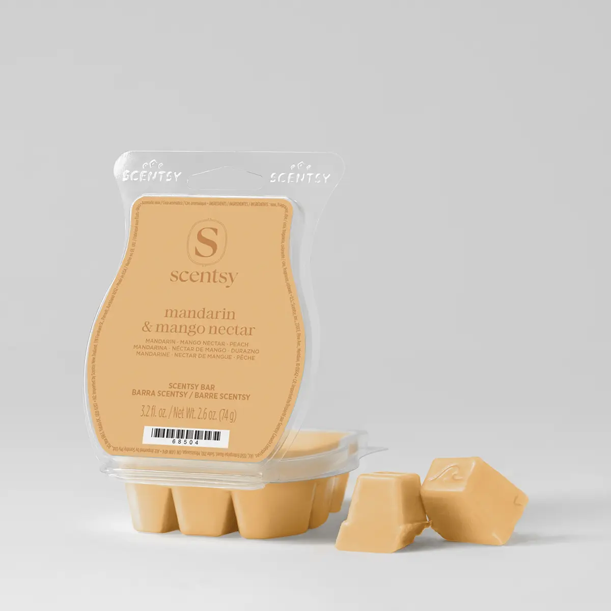 Pale peach-coloured wax bar in clear plastic clamshell packaging labelled "mandarin & mango nectar", with three individual wax chunks displayed in front