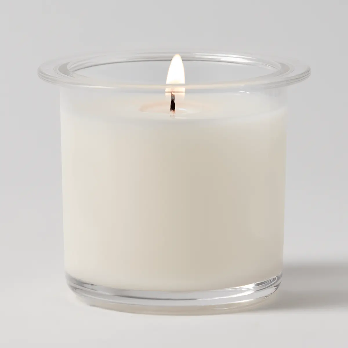Cream wax candle in a clear glass vessel with a flared rim and cotton wick, the Sugared Peppermint Pine Candle Insert