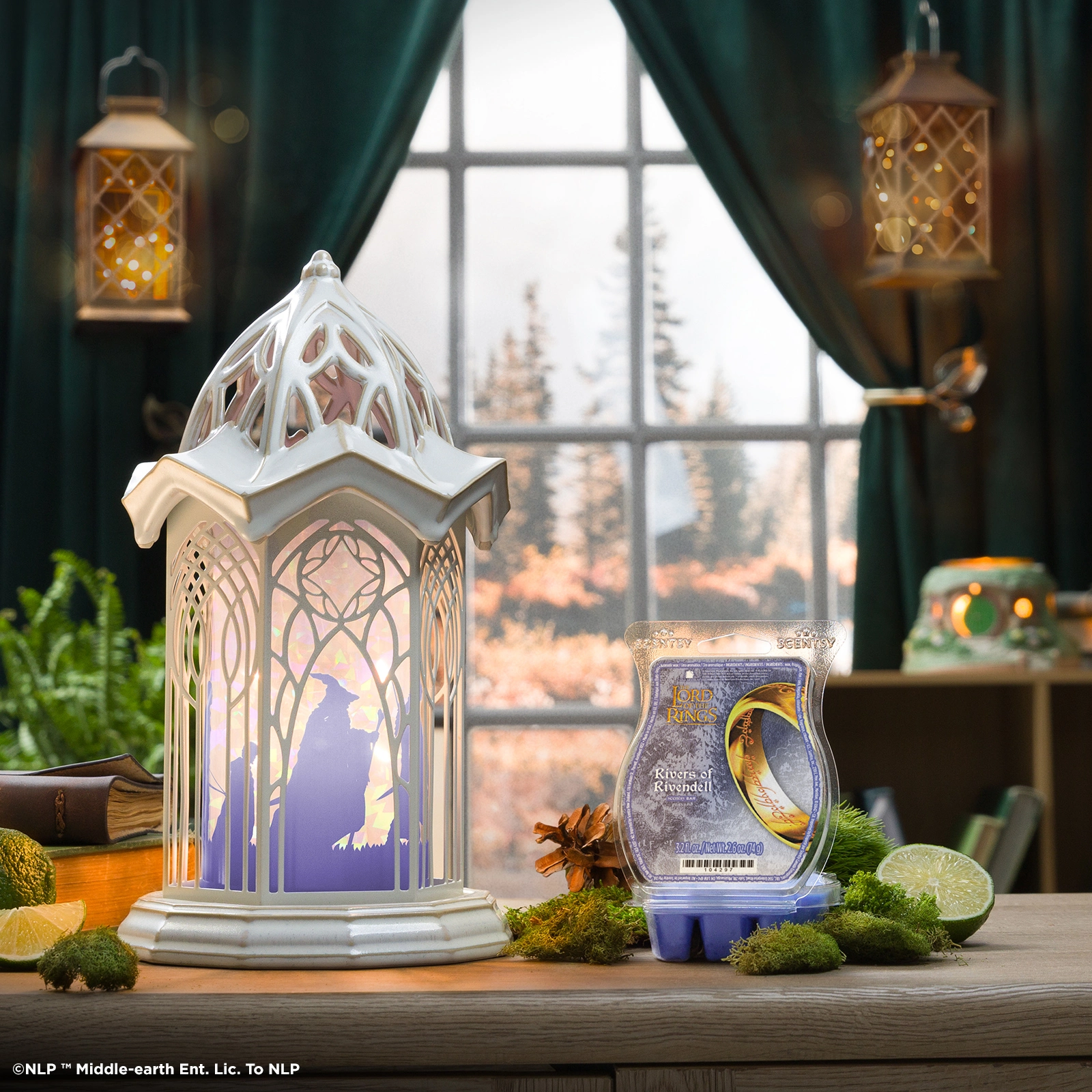 Ornate white ceramic warmer with an arched cathedral design featuring a silhouette of Rivendell's architecture and illuminated interior, the Lord of the Rings: Rivendell Scentsy Warmer, displayed beside a matching wax melt package on a wooden table