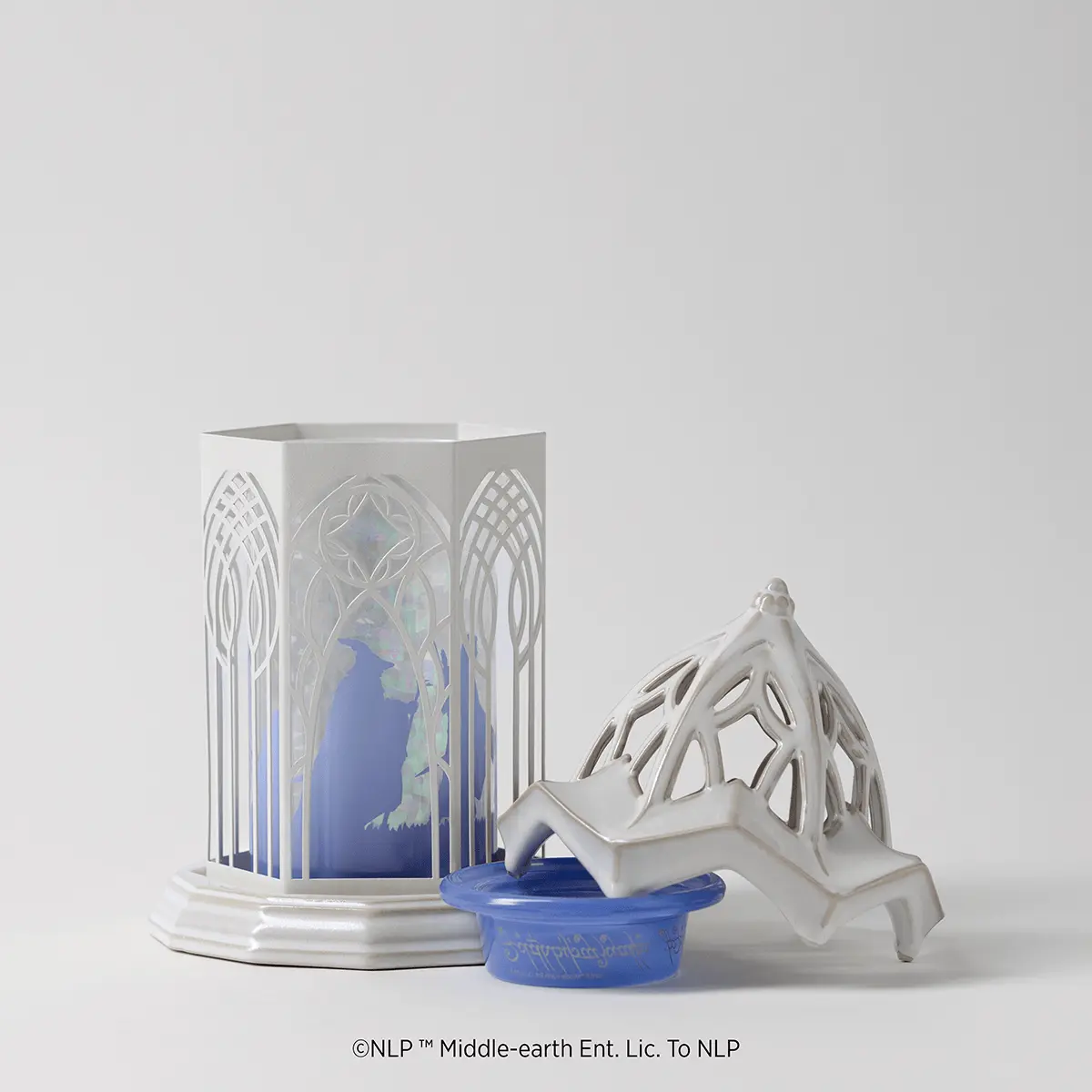 White ceramic warmer with ornate arched panels and blue gradient insert featuring a silhouette of Rivendell, with removable decorative tree-shaped lid, the Lord of the Rings: Rivendell Scentsy Warmer