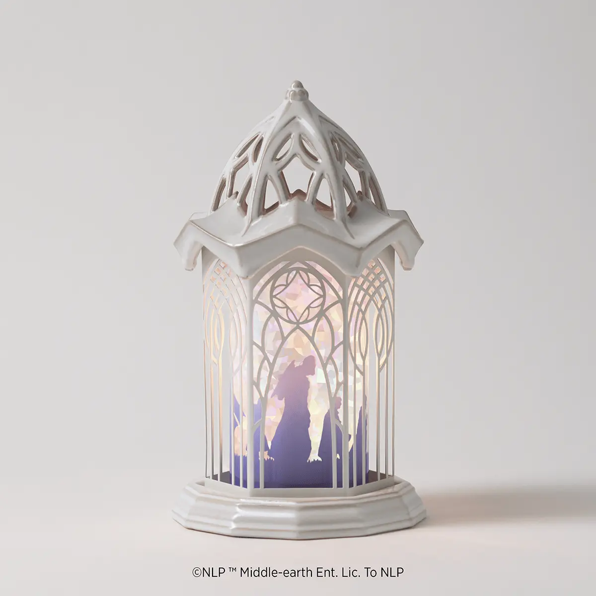 White ceramic lantern-style warmer with an ornate pointed roof and gothic window design featuring a silhouette of a figure in an arched frame, the Lord Of The Rings: Rivendell Scentsy Warmer