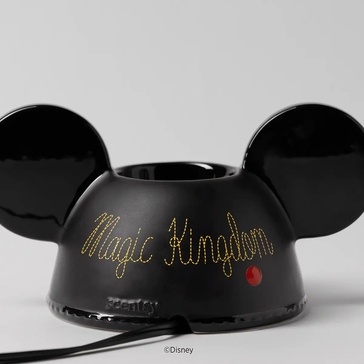 Black ceramic warmer shaped like Mickey Mouse's head with rounded ears, gold embroidered text reading "Magic Kingdom" and a red nose detail, the Walt Disney World: Embroidered Mickey Ears Scentsy Warmer