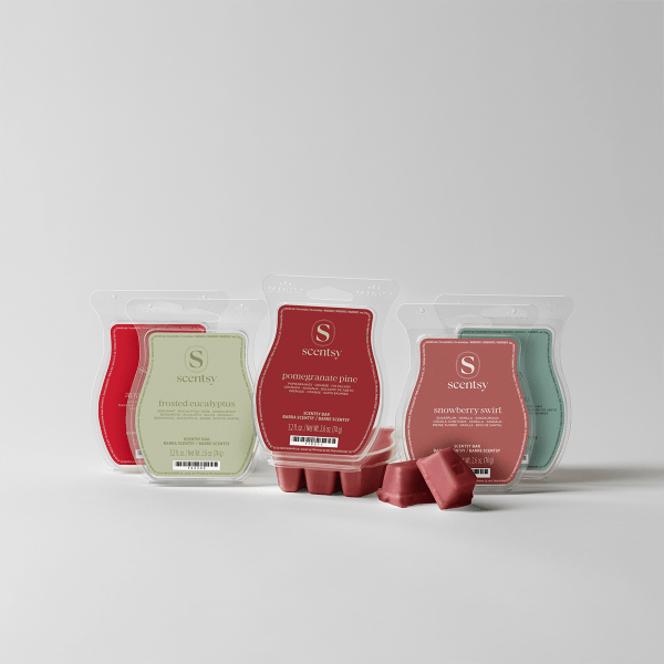 Five Scentsy wax bars in bubble-shaped clear packs with red, sage green, pink and teal labels, with loose red wax cubes, the Alpine Holiday Scentsy Bar 5-pack