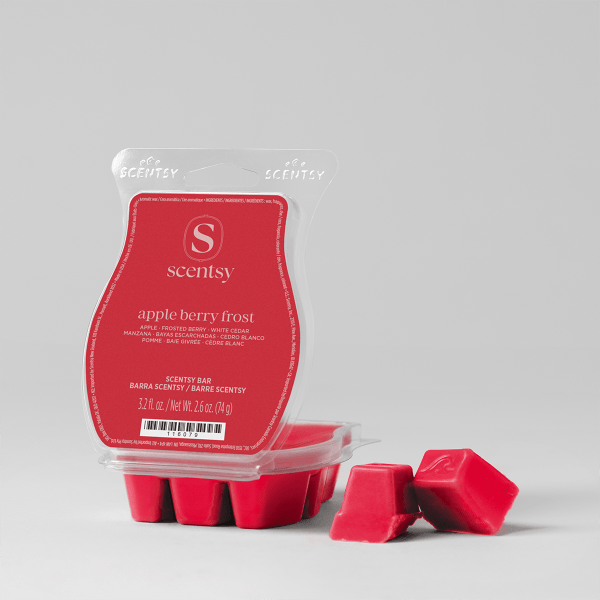 Red wax cubes beside a clear clamshell pack with a red Scentsy label, the Apple Berry Frost Scentsy Bar, on a light grey backdrop