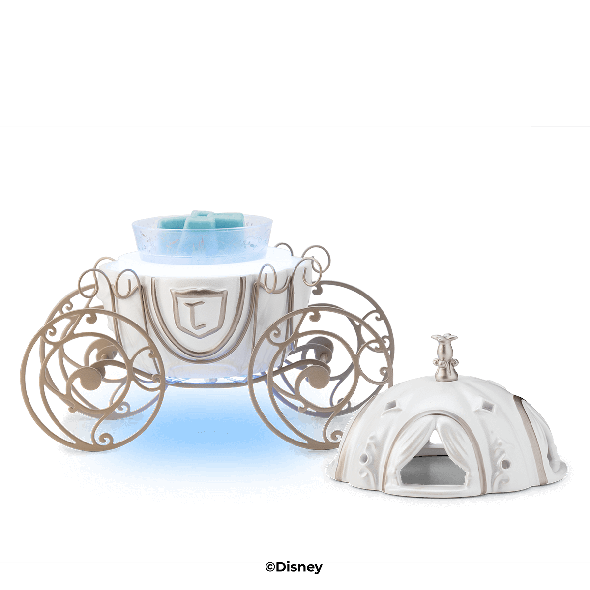 Ceramic pumpkin carriage warmer with gold scroll wheels, glass dish of blue wax and removable domed lid set alongside