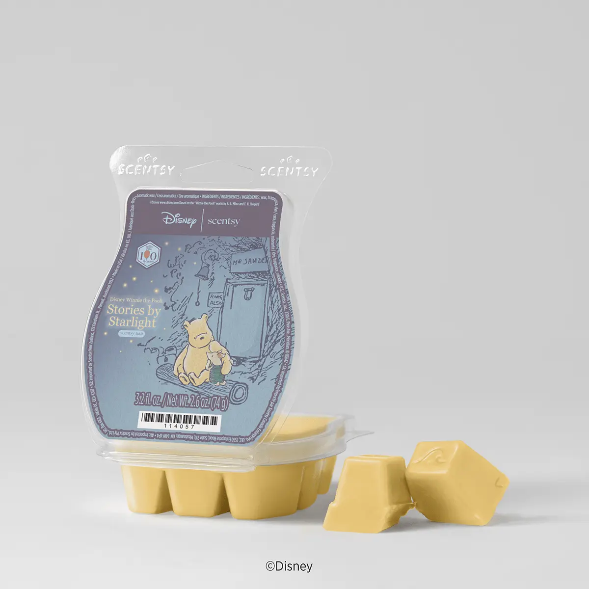 Pale yellow wax cubes beside a clear clamshell pack with a blue-grey Pooh and Piglet storybook label, the Disney Winnie the Pooh: Stories by Starlight Scentsy Bar