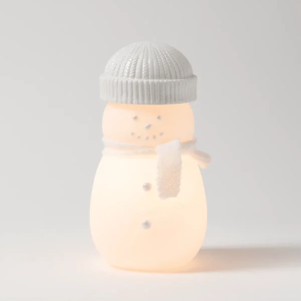 Glowing frosted white snowman with a grey knit-textured ceramic beanie, a white knitted scarf and silver dot features, the Frosty Charm Scentsy Warmer